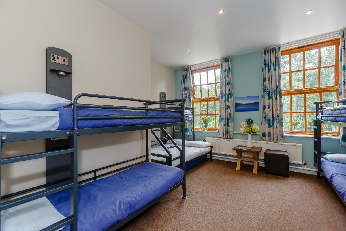 Bedroom with bunk beds and blue sheets at YHA Osmotherley